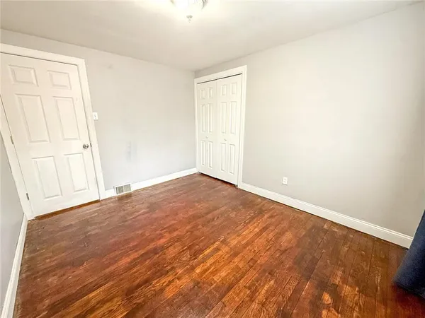 an empty room with wooden floor