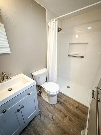 a white toilet sitting next to a bathroom sink