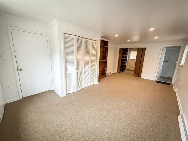 a view of an empty room with a closet