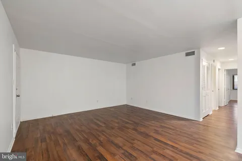 a view of a room with wooden floor