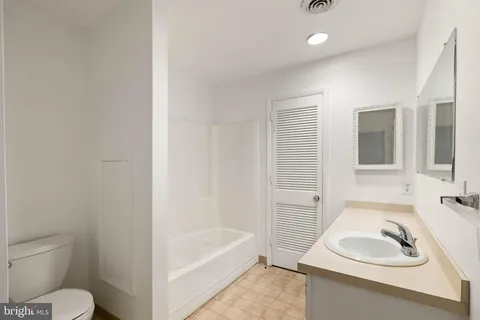 a bathroom with a sink toilet and bathtub