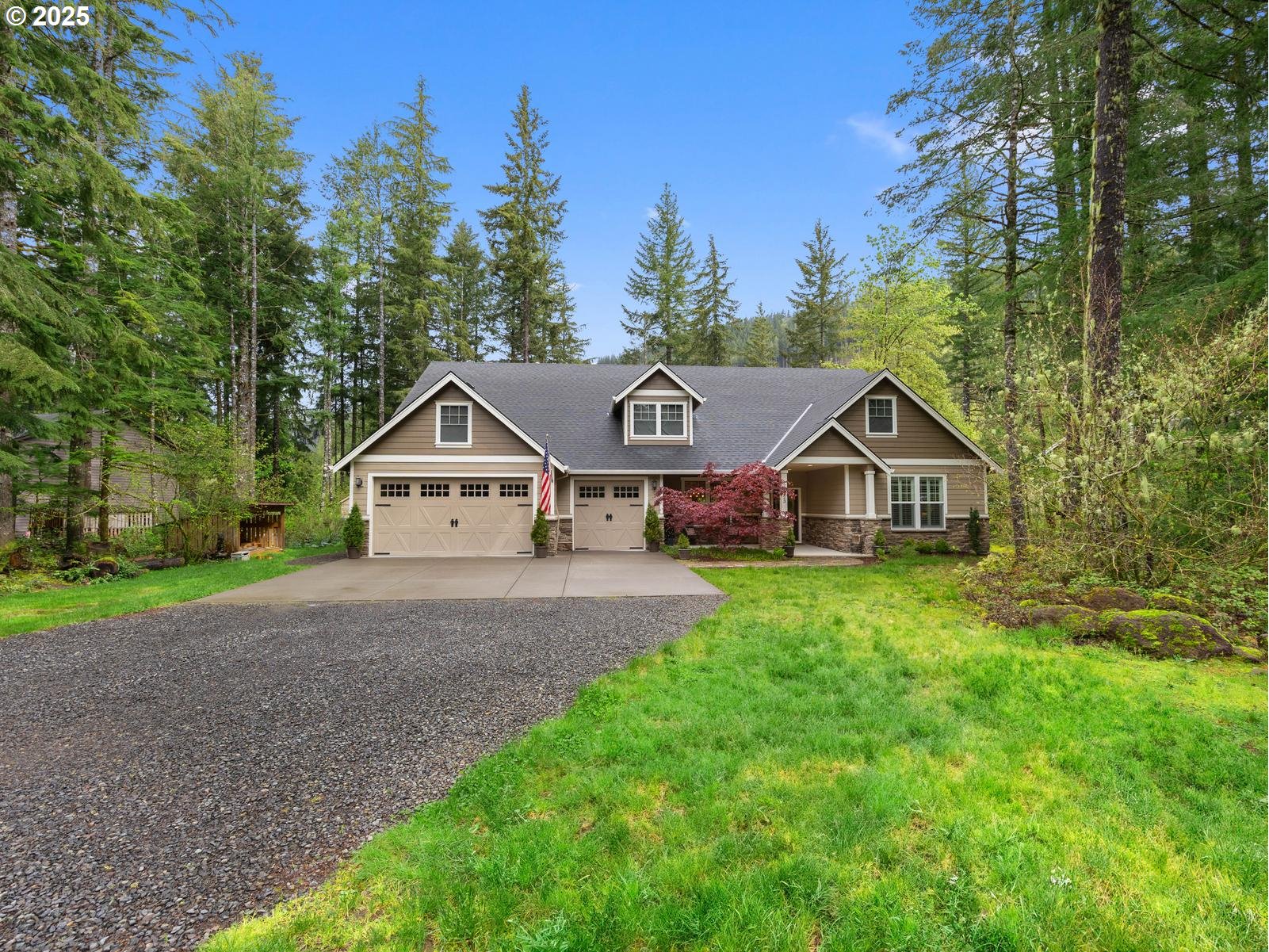 23323 East Wind Tree Loop Rhododendron, OR 97049 - Photo 1 of 43 a front of a house with a yard and large trees