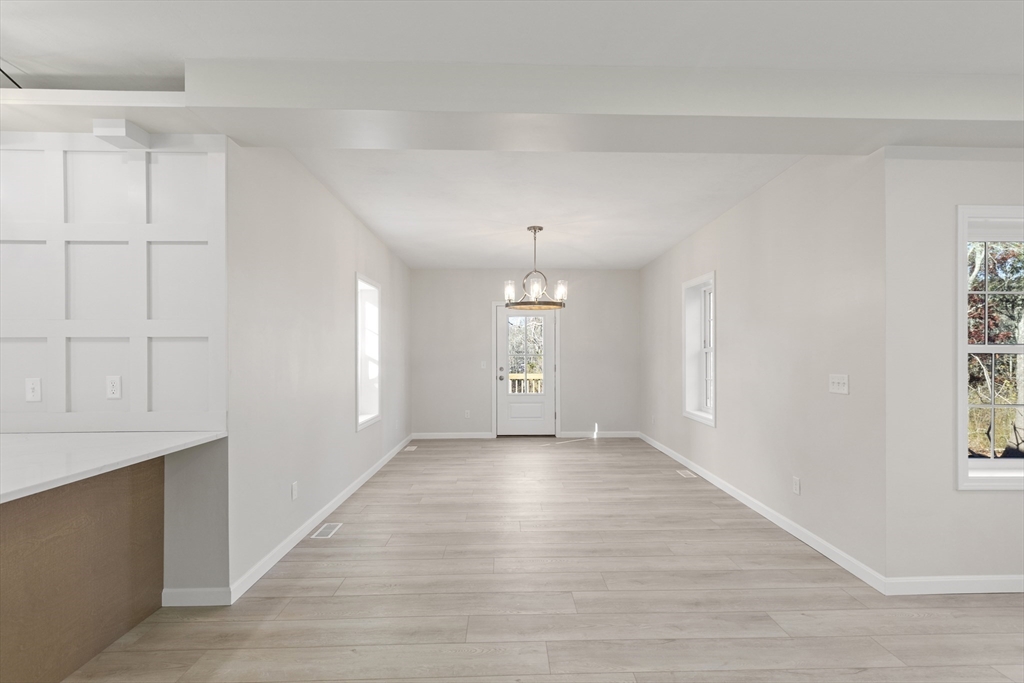 1234 State Road, Unit 1 Plymouth, MA 02360 - Photo 16 of 32 a view of an empty room with window and wooden floor