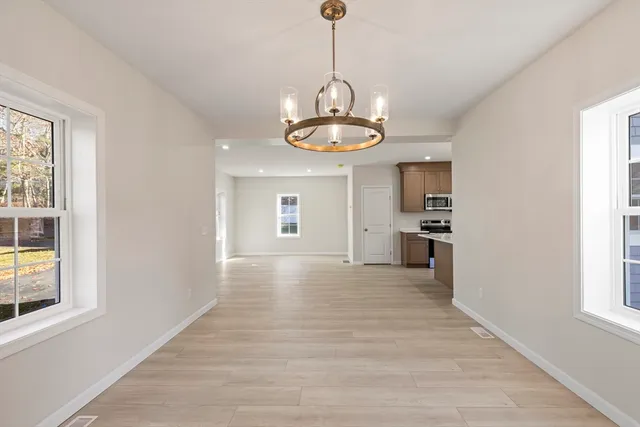 a view of a kitchen with a sink dishwasher and wooden floor