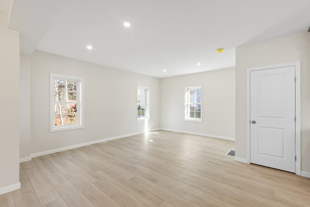 1234 State Road, Unit 1 Plymouth, MA 02360 - Photo 21 of 32 an empty room with wooden floor and windows