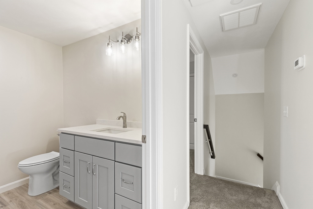 1234 State Road, Unit 1 Plymouth, MA 02360 - Photo 24 of 32 a bathroom with a toilet sink and mirror