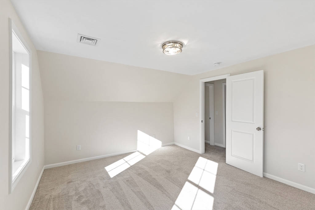 1234 State Road, Unit 1 Plymouth, MA 02360 - Photo 28 of 32 a view of a room with wooden floor and white walls