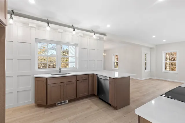 a kitchen with stainless steel appliances granite countertop cabinets and wooden floor