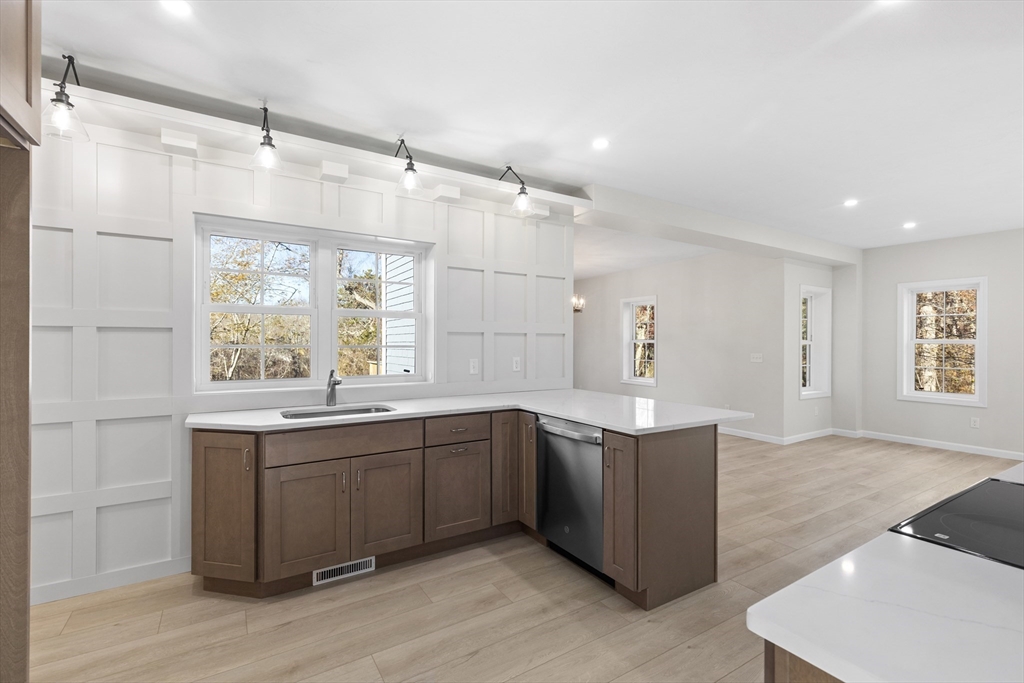 1234 State Road, Unit 1 Plymouth, MA 02360 - Photo 3 of 32 a kitchen with stainless steel appliances granite countertop cabinets and wooden floor