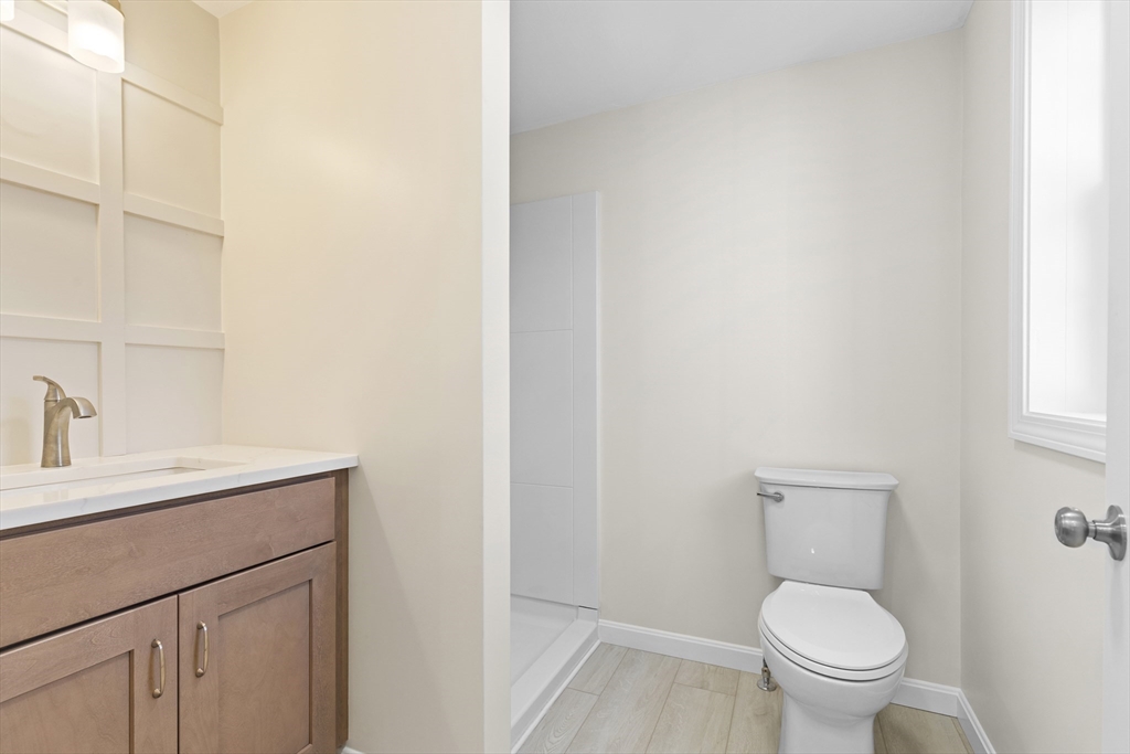 1234 State Road, Unit 1 Plymouth, MA 02360 - Photo 7 of 32 a bathroom with a toilet a sink and mirror