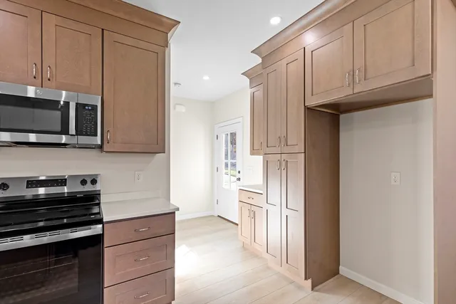 a kitchen with stainless steel appliances granite countertop a refrigerator stove and cabinets