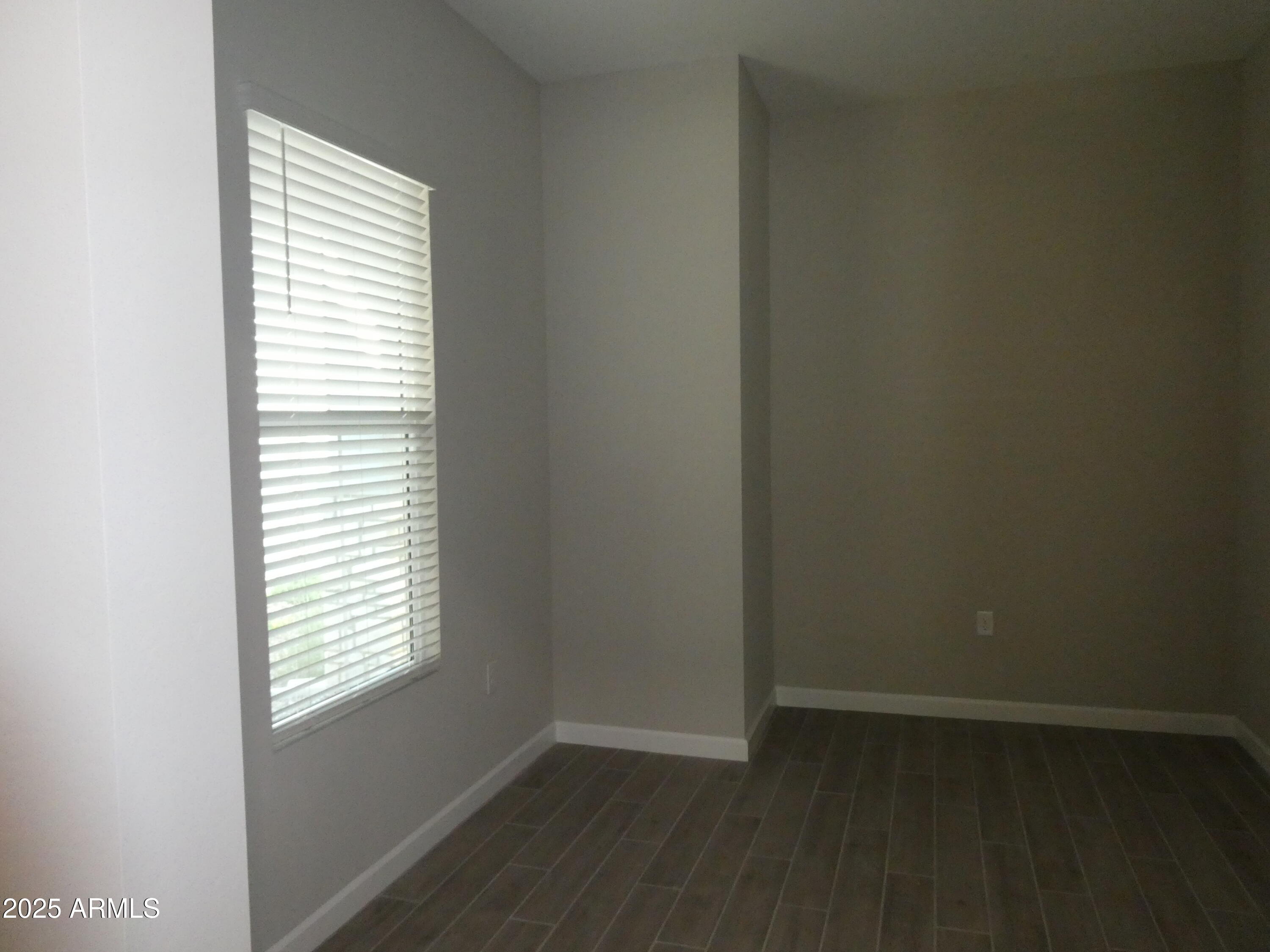 5027 Gallop Way Scottsdale, AZ 85254 - Photo 15 of 25 an empty room with wooden floor and a window