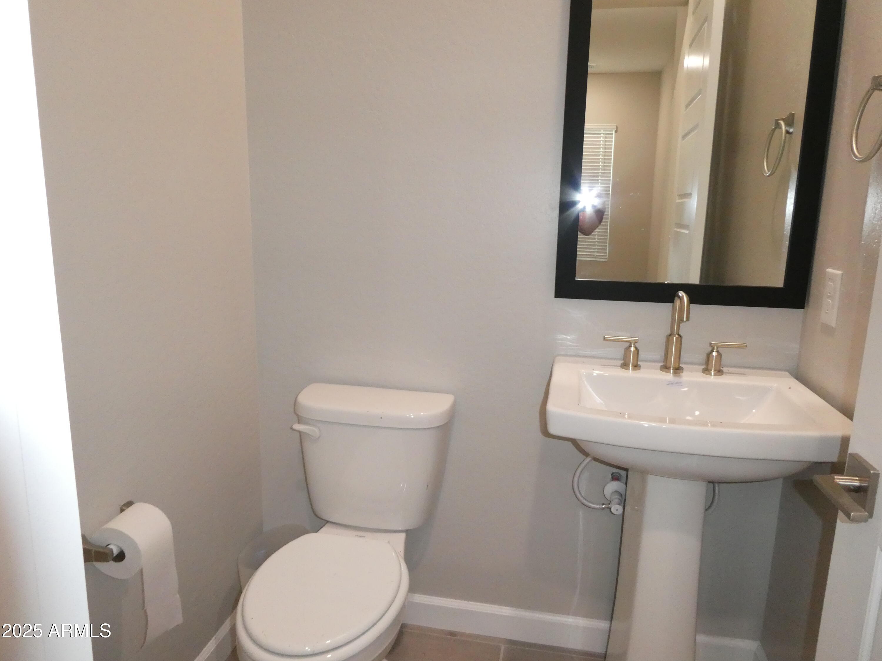 5027 Gallop Way Scottsdale, AZ 85254 - Photo 17 of 25 a bathroom with a toilet sink and mirror