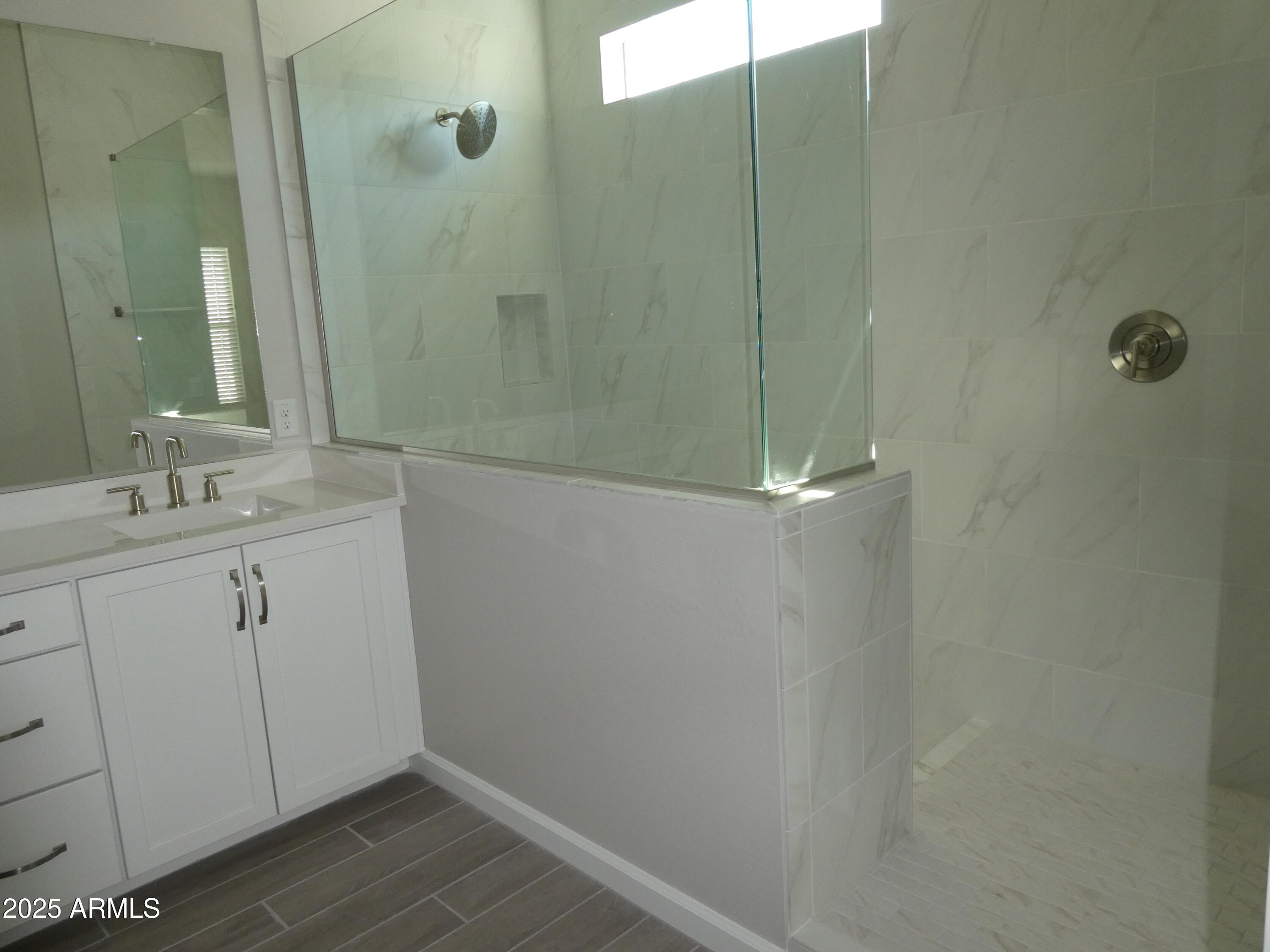 5027 Gallop Way Scottsdale, AZ 85254 - Photo 22 of 25 a bathroom with a sink a mirror and shower