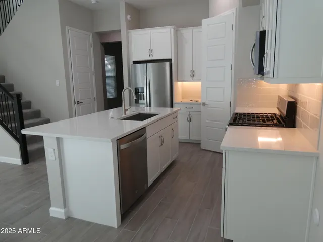 a kitchen with a stove a refrigerator and a stove