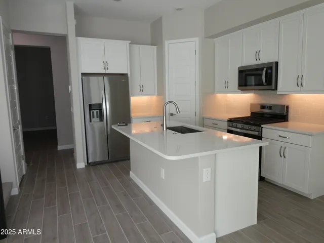 a kitchen with a refrigerator stove and microwave