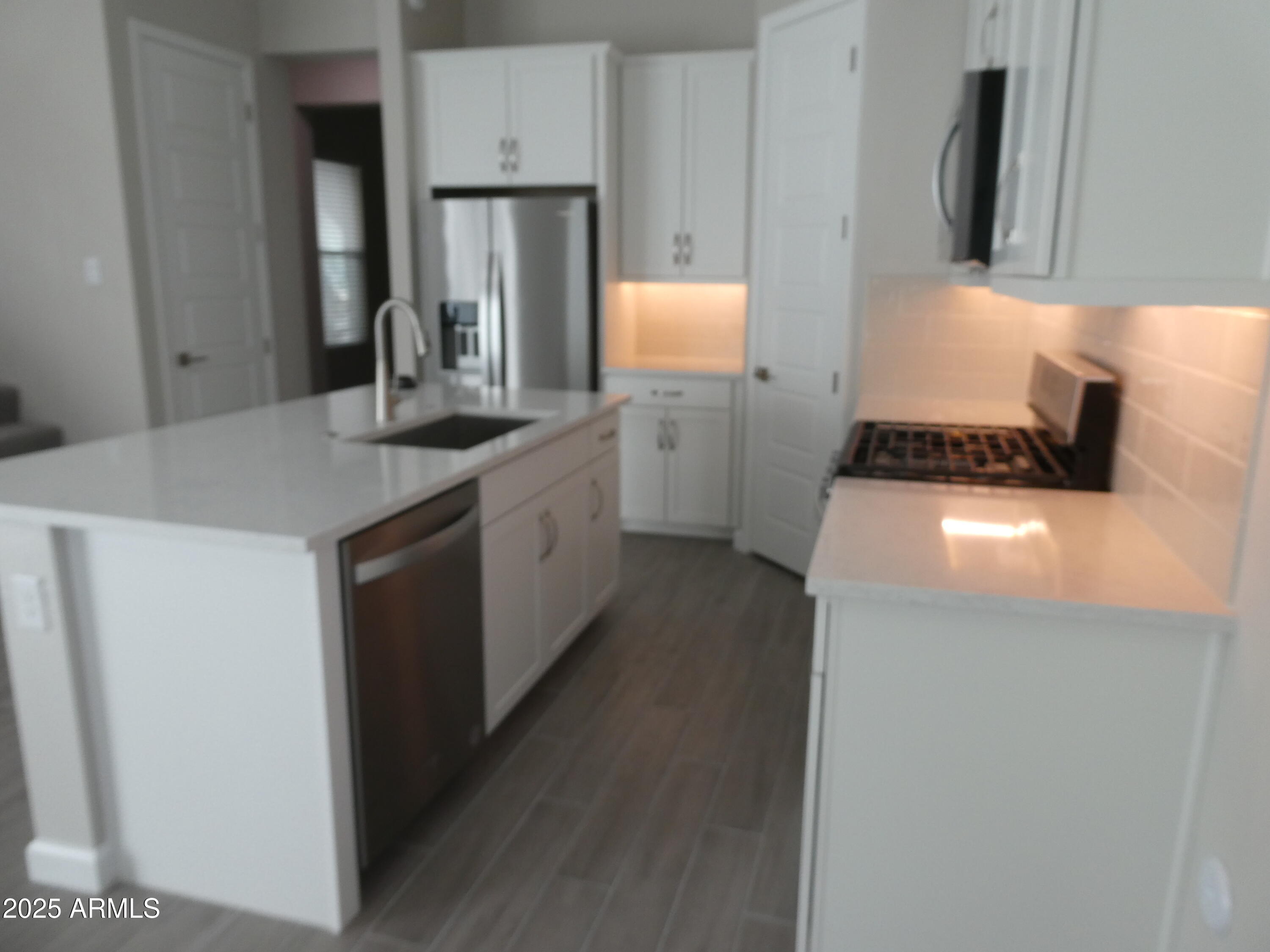 5027 Gallop Way Scottsdale, AZ 85254 - Photo 9 of 25 a kitchen with a sink a stove and refrigerator