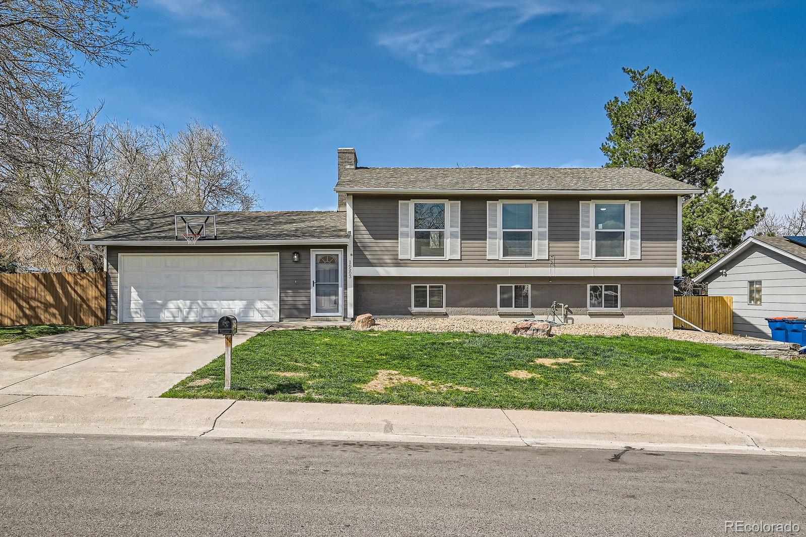 16503 East Yale Place Aurora, CO 80013 - Photo 1 of 28 a front view of a house with a yard and a garage