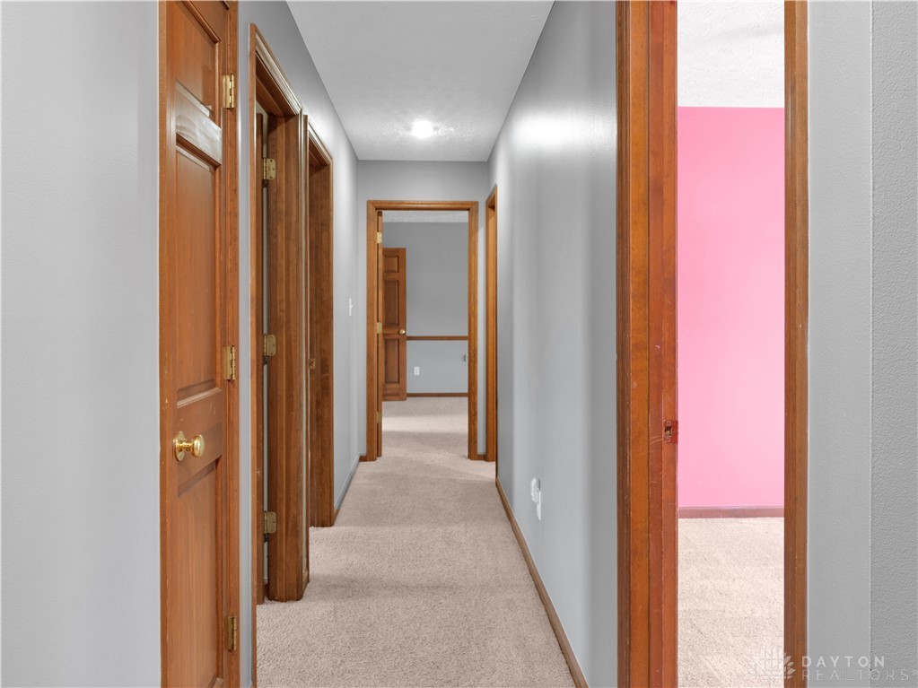 25 Callaway Springboro, OH 45066 - Photo 24 of 51 This home features a functional hallway with warm wood doors, creating a welcoming and classic interior.