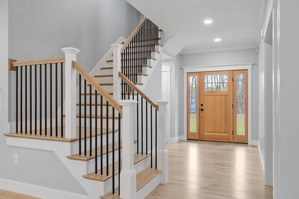 a view of staircase with railing and white walls