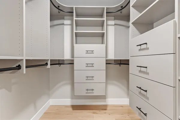 a view of walk in closet with empty racks
