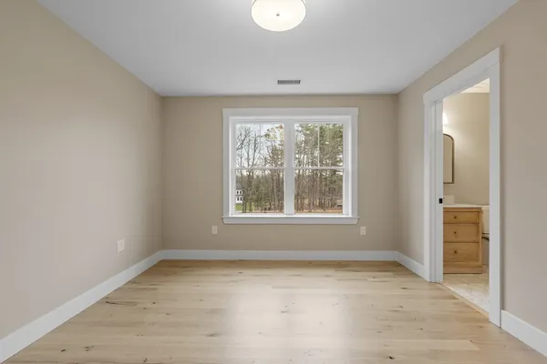 an empty room with windows and closet