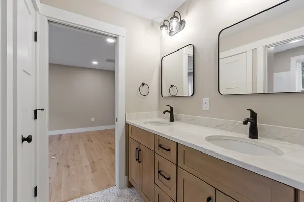 a bathroom with a double vanity sink mirror and