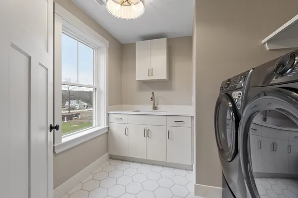 a bathroom with a sink a washer and dryer
