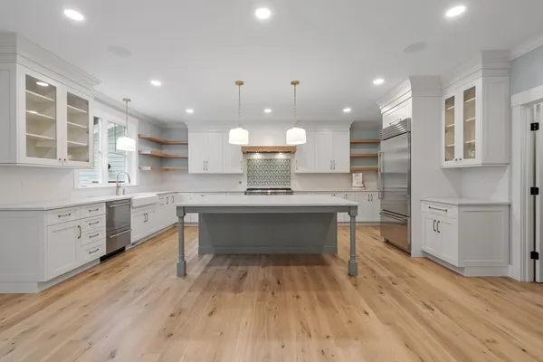 a kitchen with a sink cabinets and wooden floor