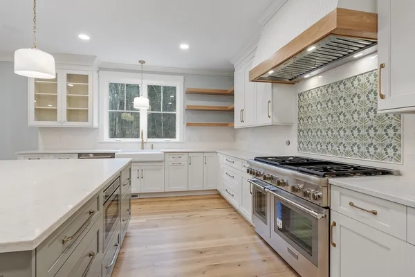 a kitchen with a stove and a sink