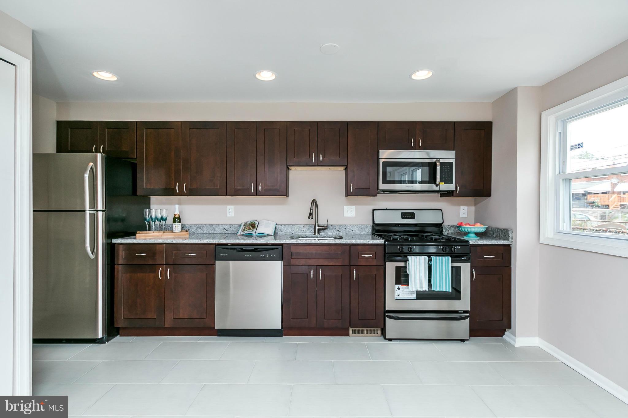 5417 Bucknell Road Baltimore, MD 21206 - Photo 13 of 30 a kitchen with stainless steel appliances granite countertop a refrigerator and a stove top oven