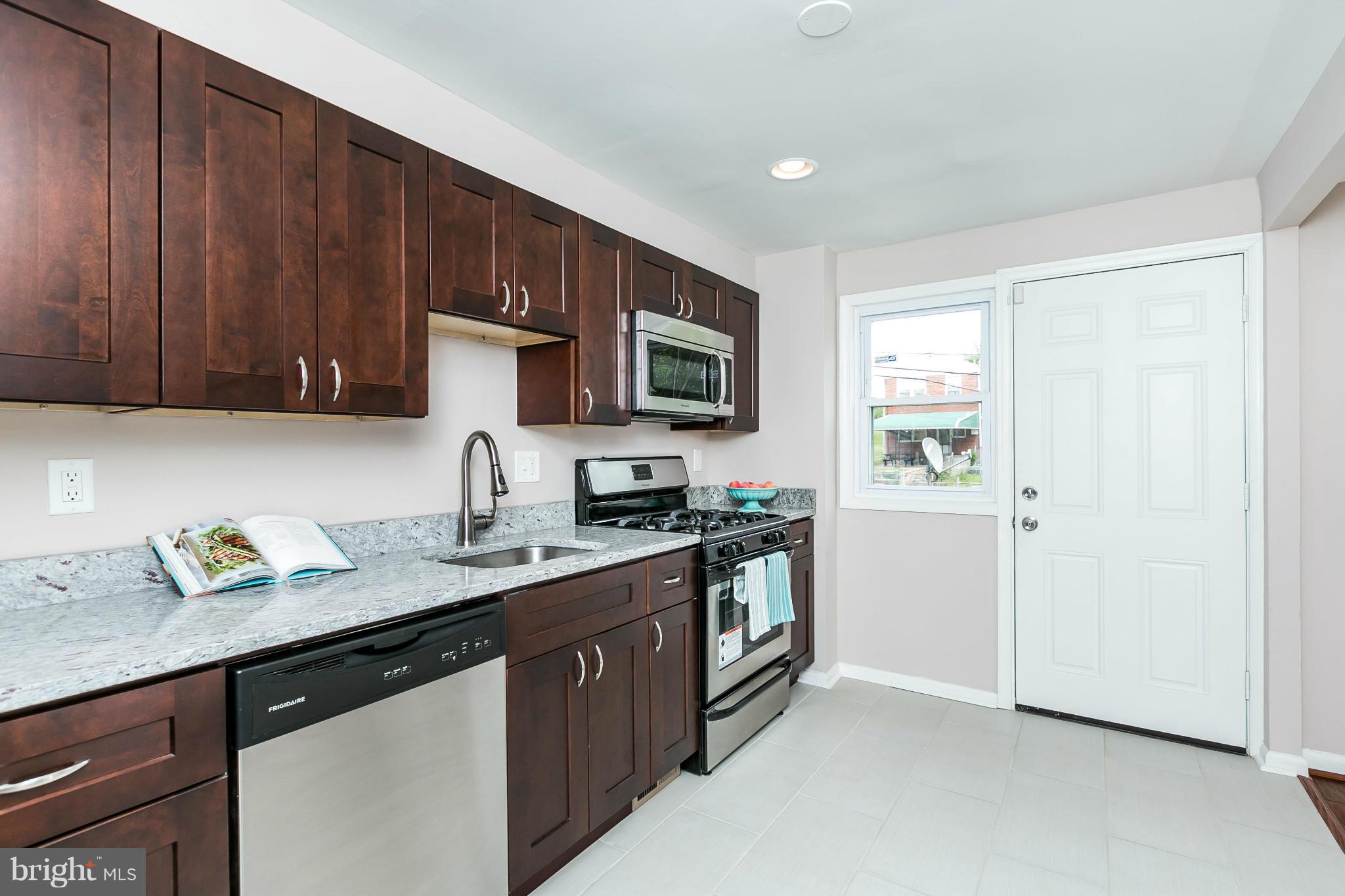 5417 Bucknell Road Baltimore, MD 21206 - Photo 15 of 30 a kitchen with stainless steel appliances granite countertop a sink stove and microwave
