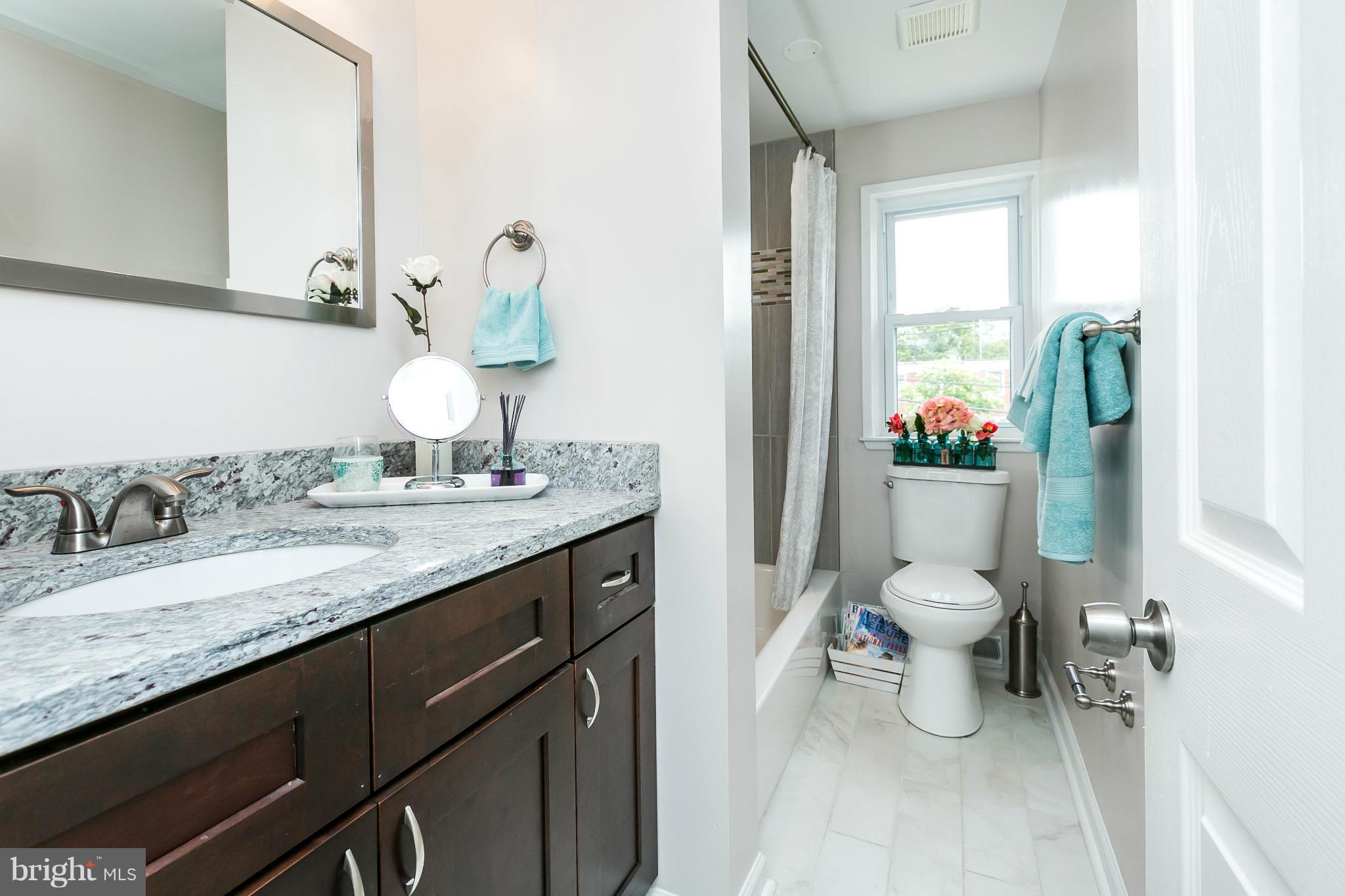 5417 Bucknell Road Baltimore, MD 21206 - Photo 22 of 30 a bathroom with a granite countertop sink mirror and toilet