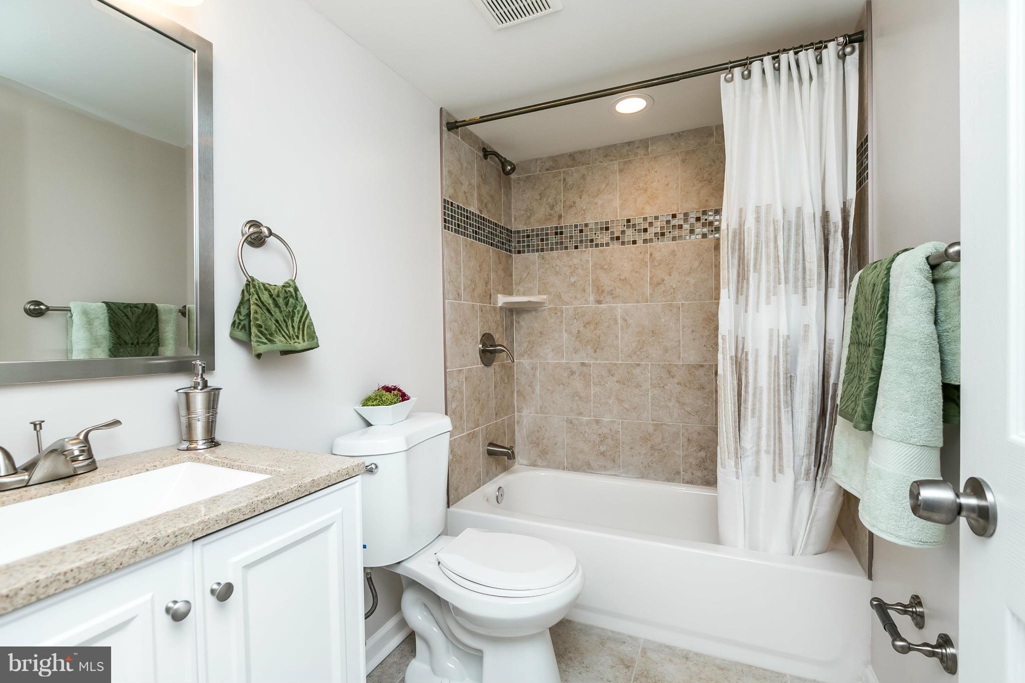 5417 Bucknell Road Baltimore, MD 21206 - Photo 26 of 30 a bathroom with a granite countertop sink toilet and shower