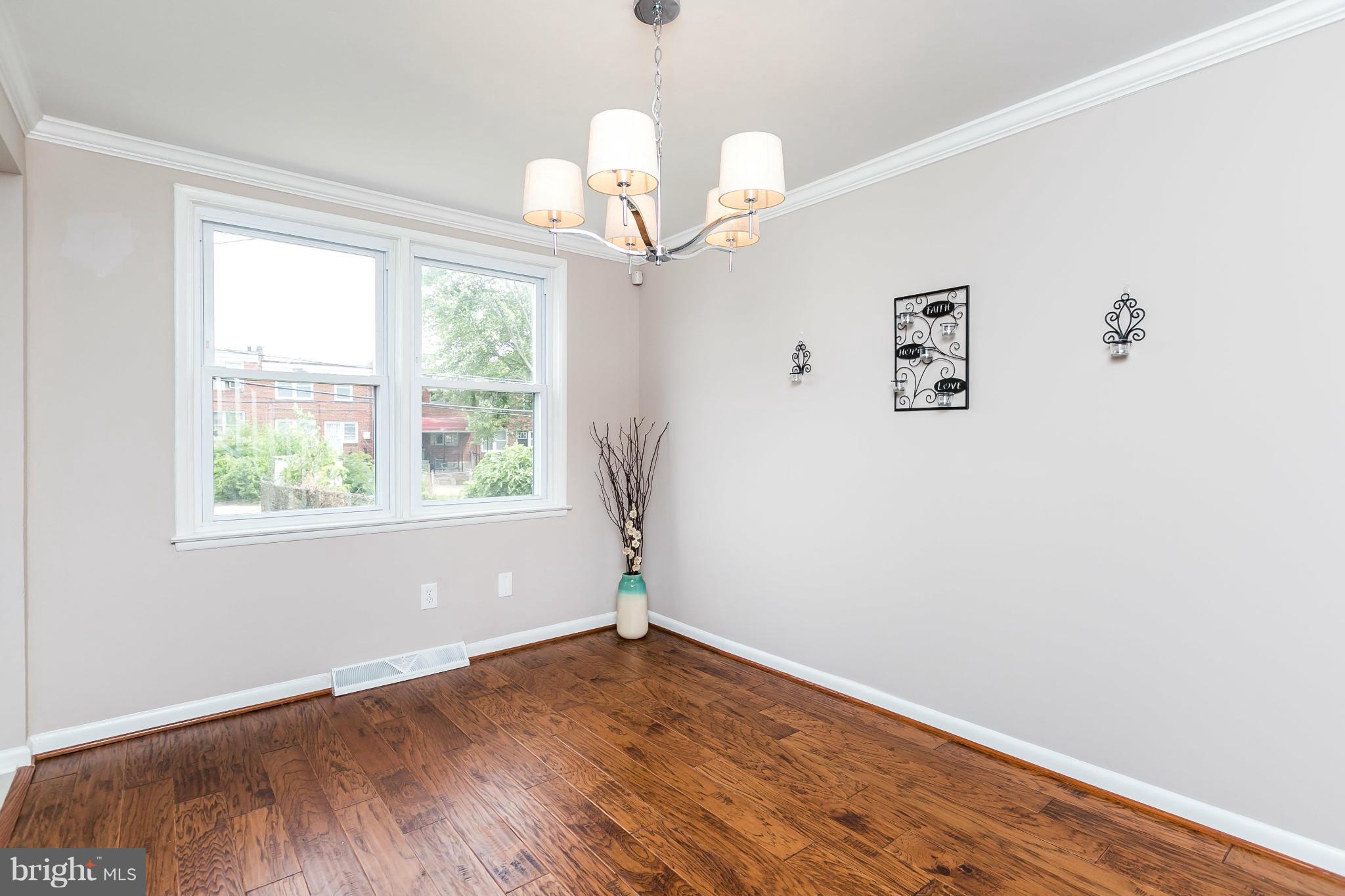 5417 Bucknell Road Baltimore, MD 21206 - Photo 8 of 30 wooden floor in an empty room with a window