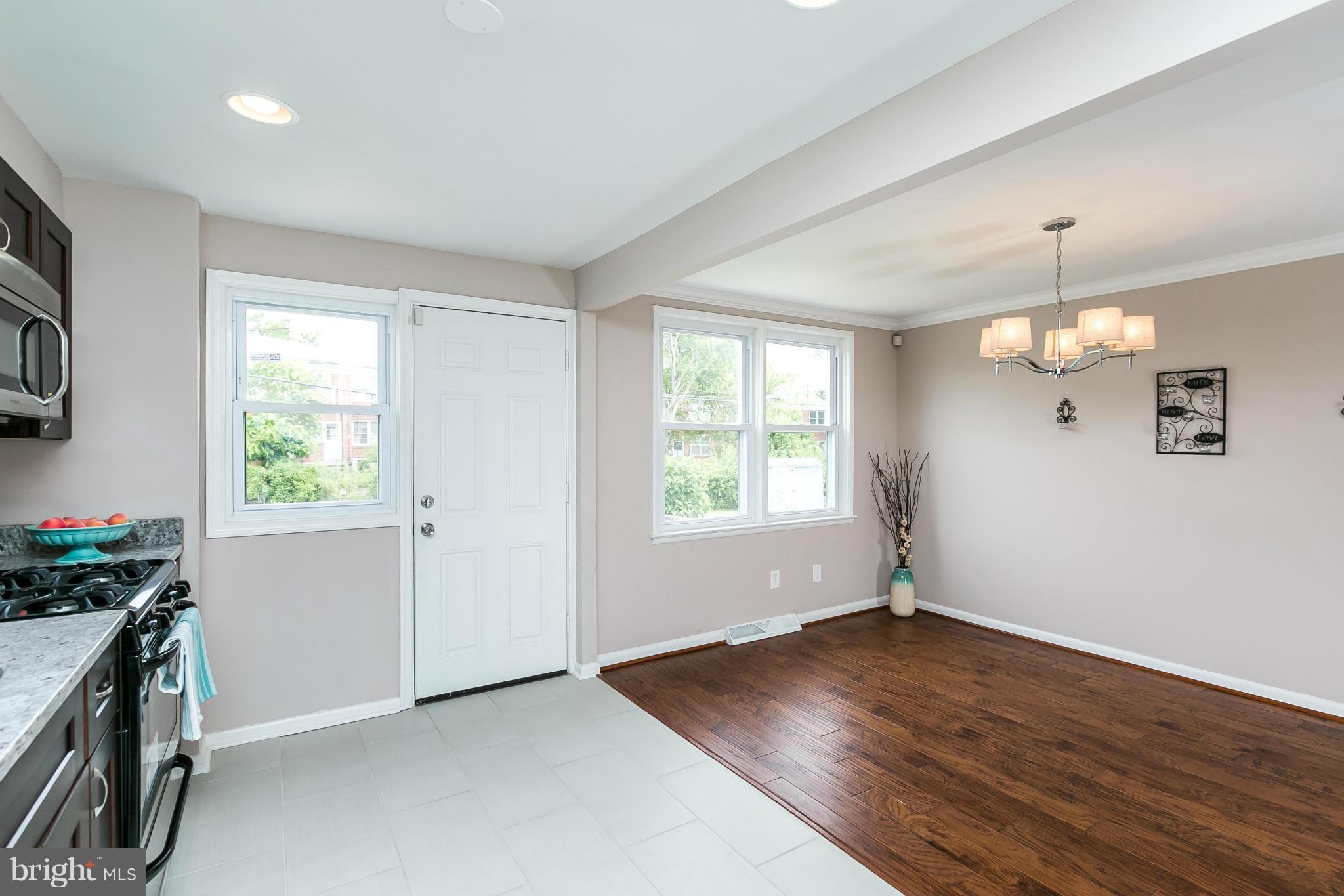 5417 Bucknell Road Baltimore, MD 21206 - Photo 10 of 30 an empty room with wooden floor and windows