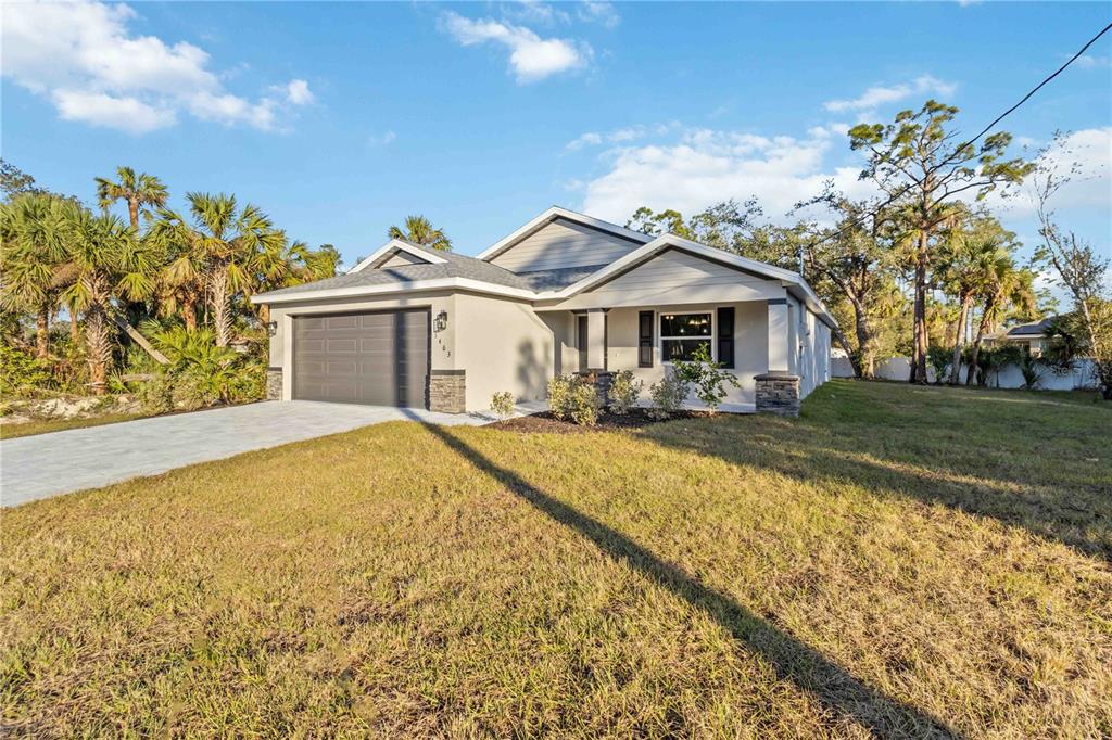 6288 Deer Run Road North Port, FL 34291 - Photo 3 of 43 a front view of a house with a yard table and chairs