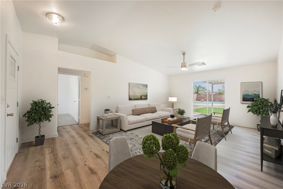 112 Iridescent Street Henderson, NV 89012 - Photo 24 of 24 Natural light bathes this spacious open floorplan, showcasing beautiful wood-style flooring and seamless outdoor access.