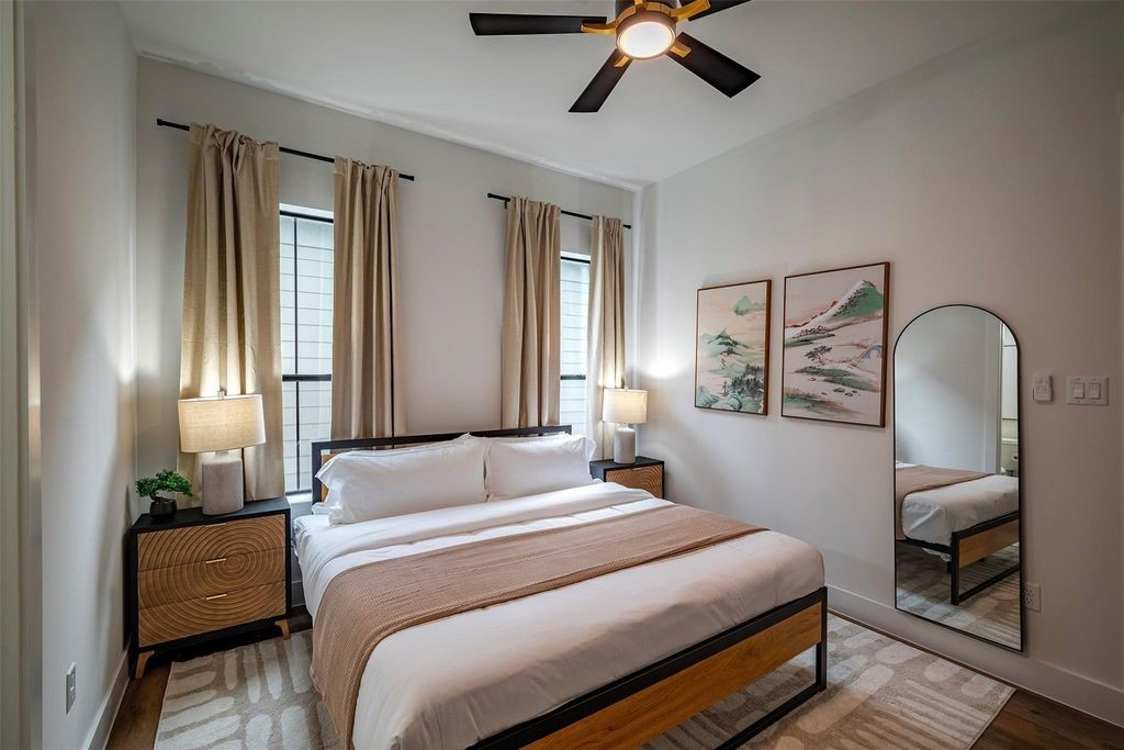 1305 East 27th Street, Unit B Houston, TX 77009 - Photo 20 of 27 a bedroom with a bed wooden floor and window