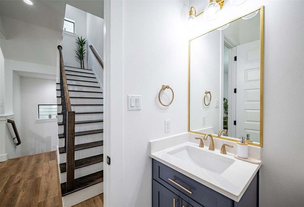 1305 East 27th Street, Unit B Houston, TX 77009 - Photo 22 of 27 a bathroom with a sink a mirror and shower