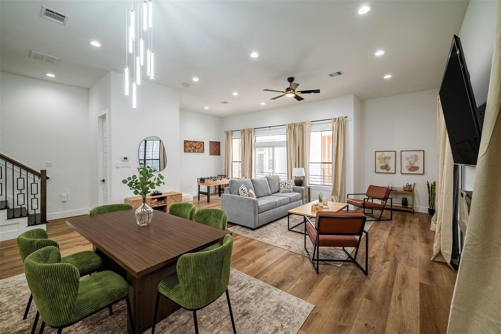1305 East 27th Street, Unit B Houston, TX 77009 - Photo 6 of 27 a living room with furniture a flat screen tv and a dining table