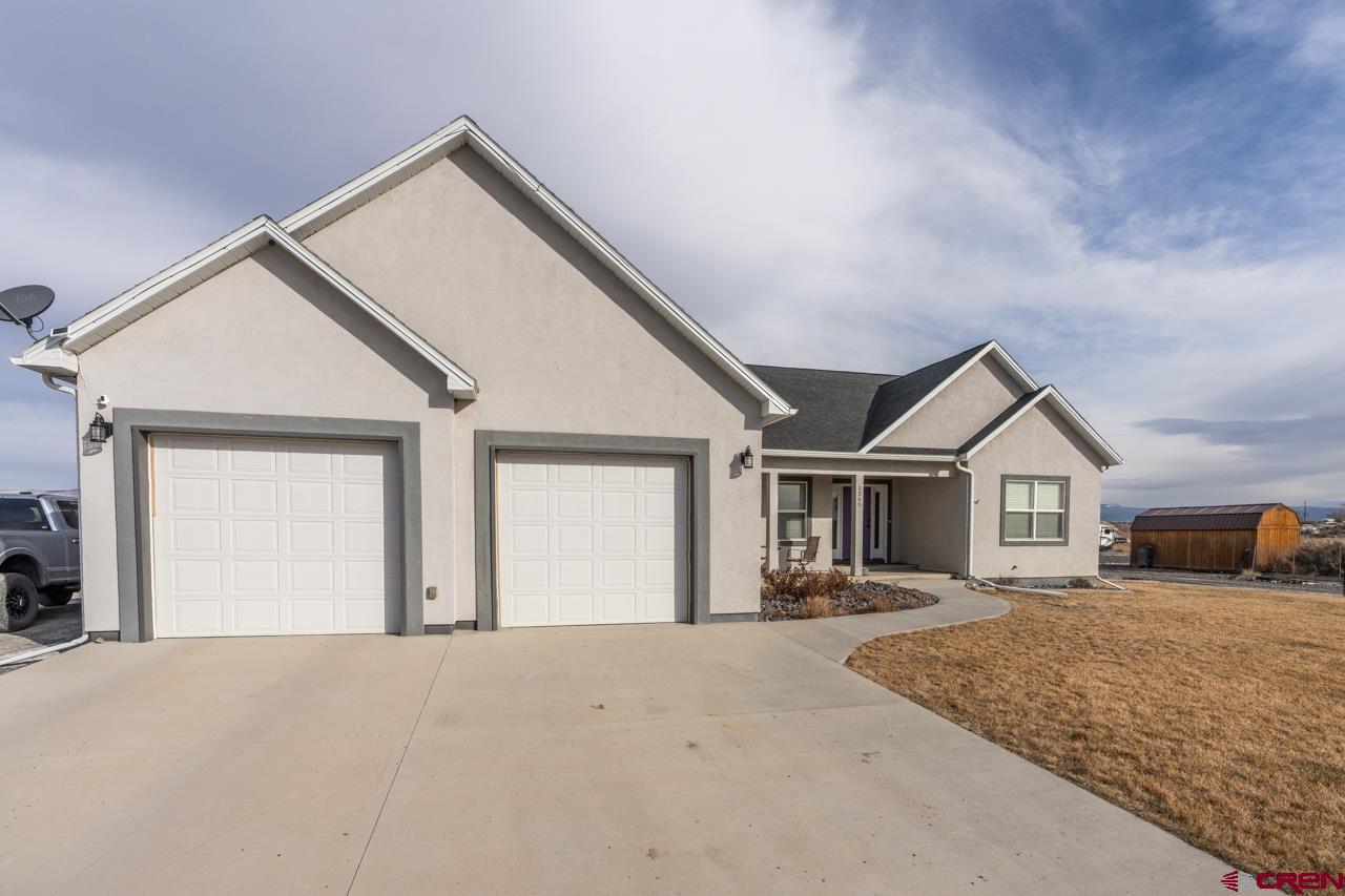 1265 H25 Road Delta, CO 81416 - Photo 1 of 34 a view of a house with a yard and garage
