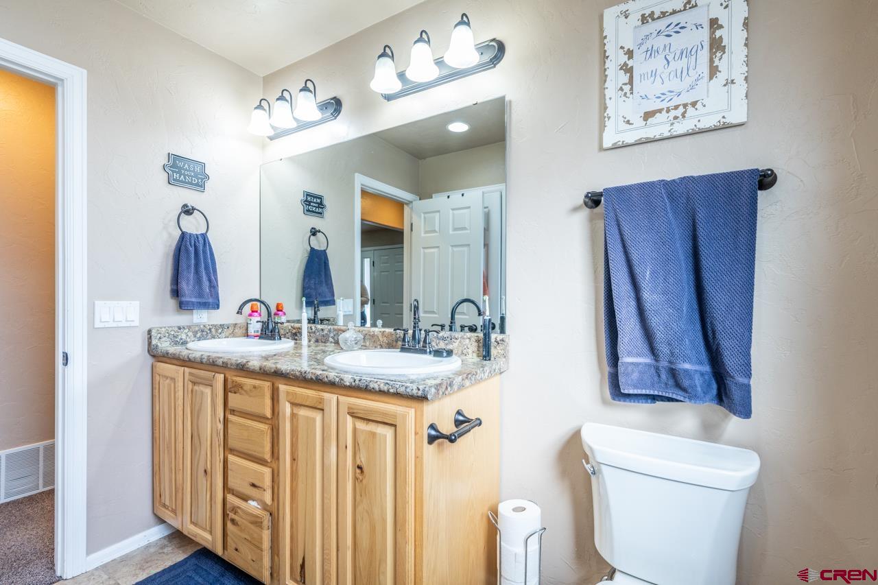 1265 H25 Road Delta, CO 81416 - Photo 15 of 34 a bathroom with a granite countertop sink and a mirror