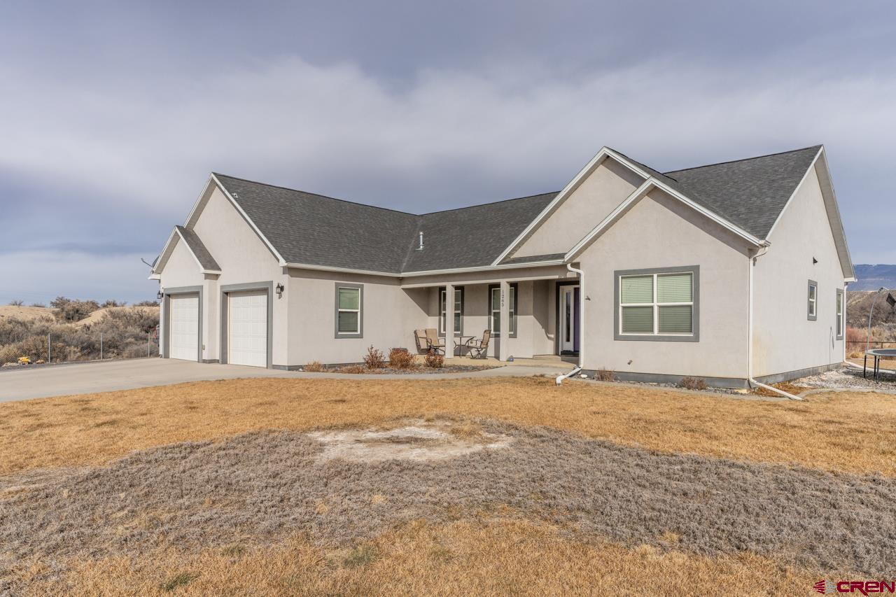 1265 H25 Road Delta, CO 81416 - Photo 2 of 34 a front view of a house with a yard and garage