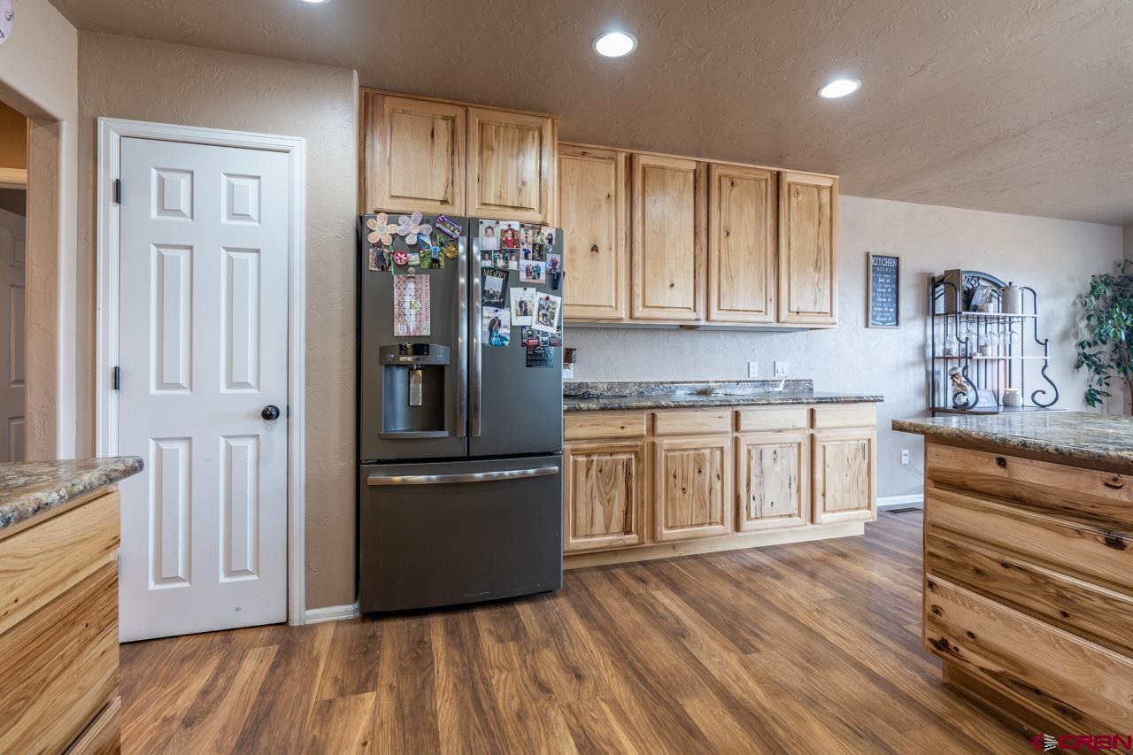 1265 H25 Road Delta, CO 81416 - Photo 22 of 34 a kitchen with granite countertop white cabinets and stainless steel appliances