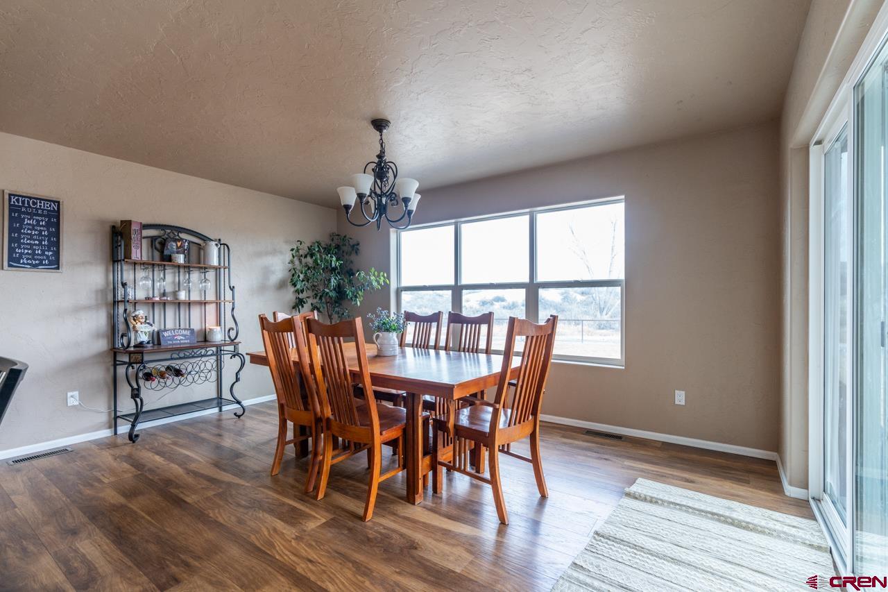 1265 H25 Road Delta, CO 81416 - Photo 23 of 34 a view of a dining room with furniture window and wooden floor