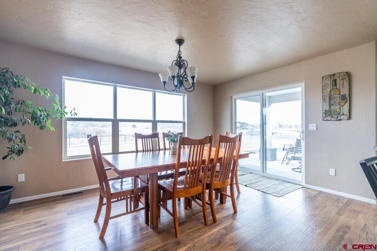1265 H25 Road Delta, CO 81416 - Photo 24 of 34 a view of a dining room with furniture window and wooden floor