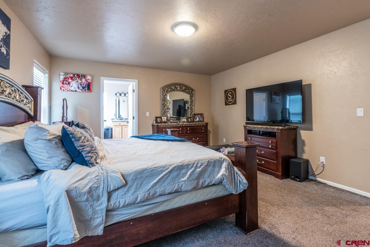1265 H25 Road Delta, CO 81416 - Photo 28 of 34 a bedroom with a bed and a flat screen tv
