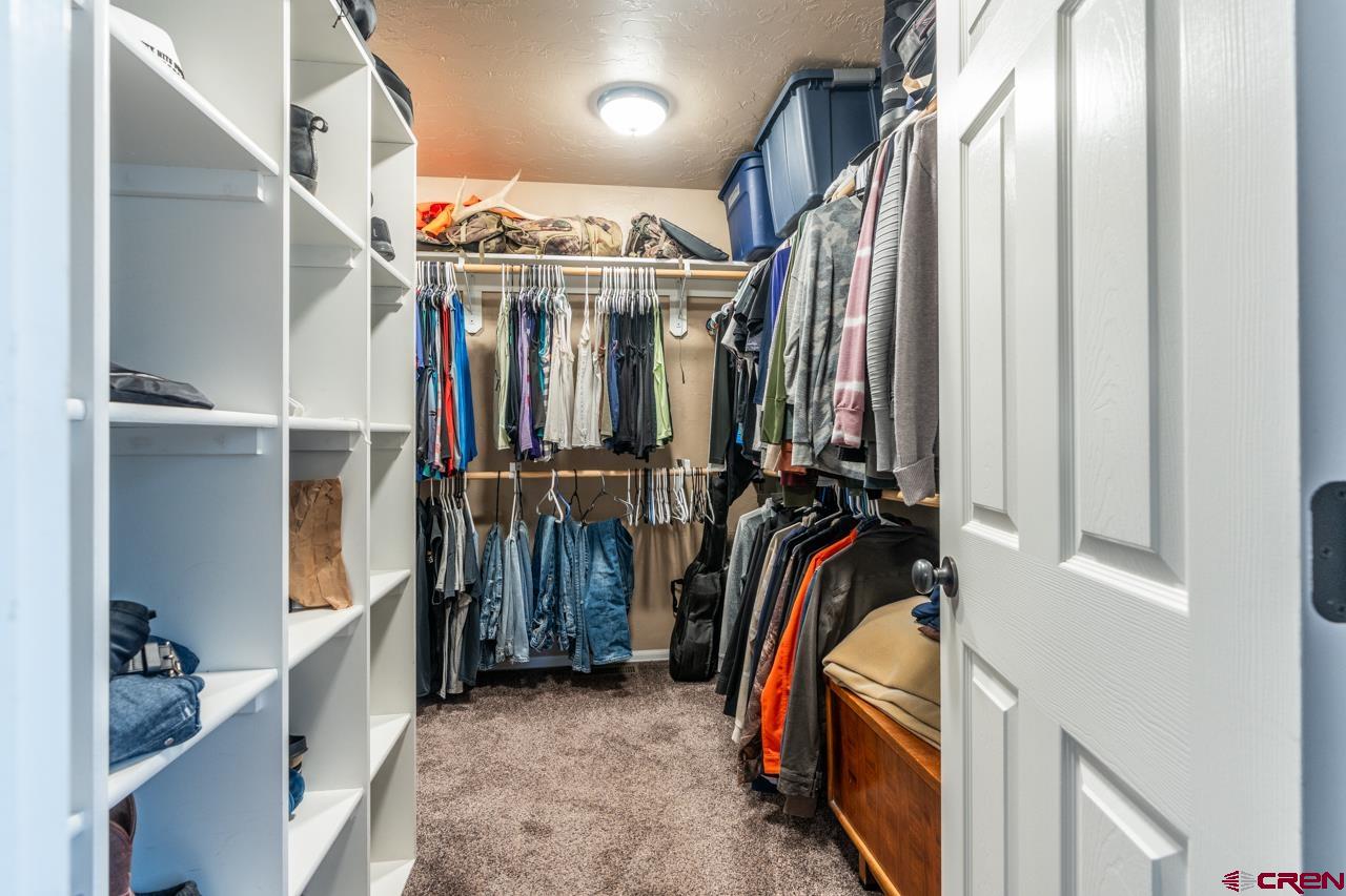 1265 H25 Road Delta, CO 81416 - Photo 30 of 34 a view of walk in closet with clothes and shoes