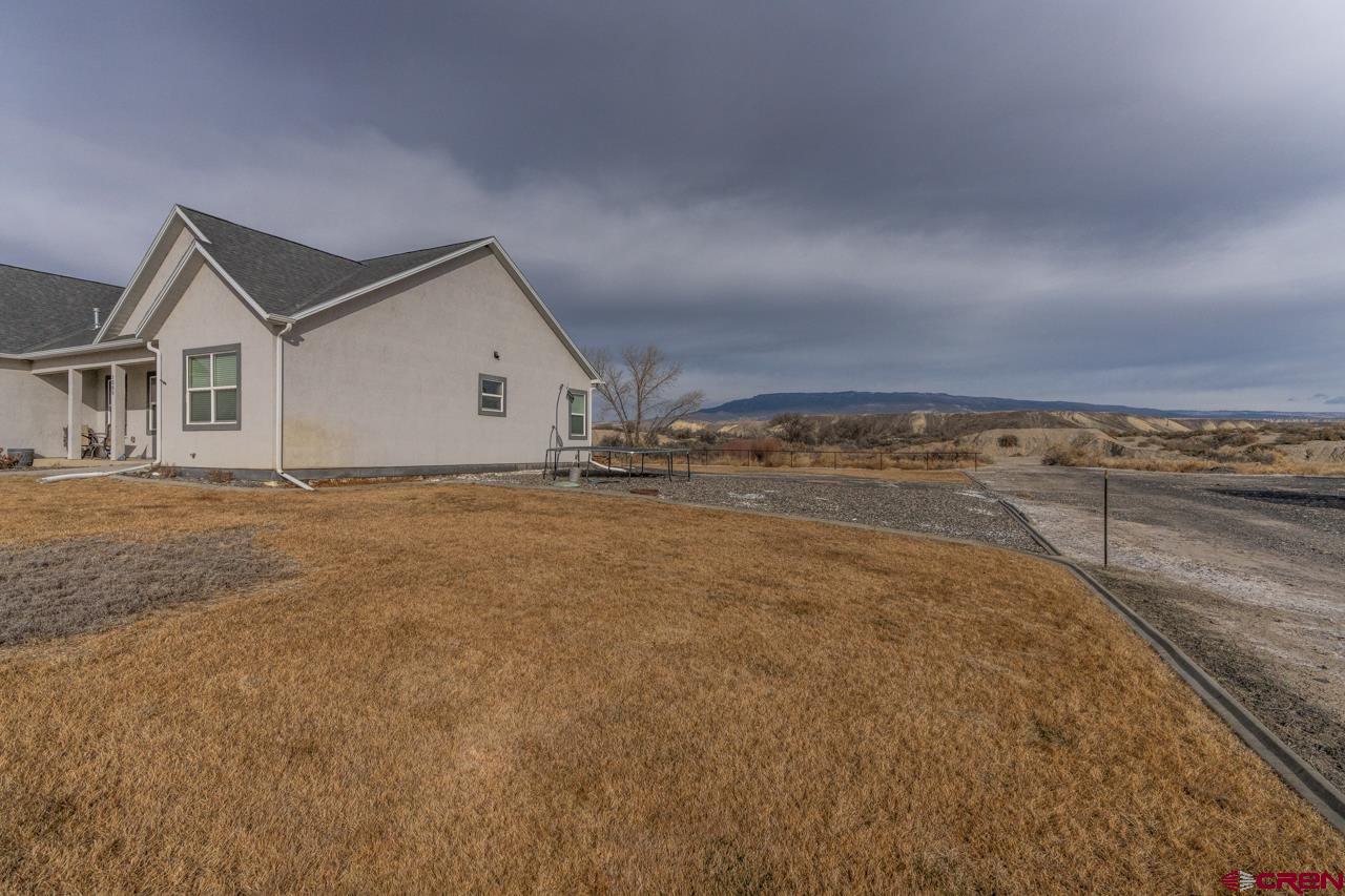 1265 H25 Road Delta, CO 81416 - Photo 3 of 34 a view of an house with backyard and tree